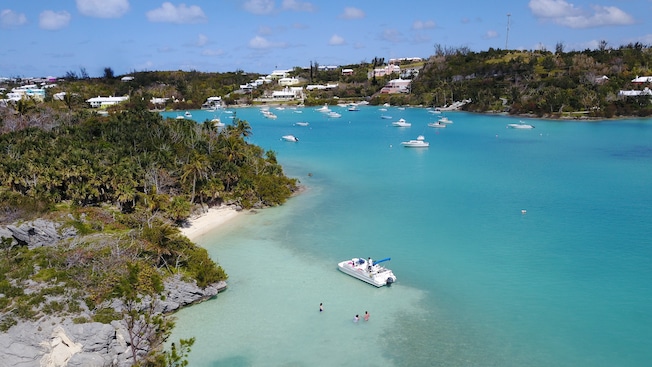 An inlet full of boats and swimmers