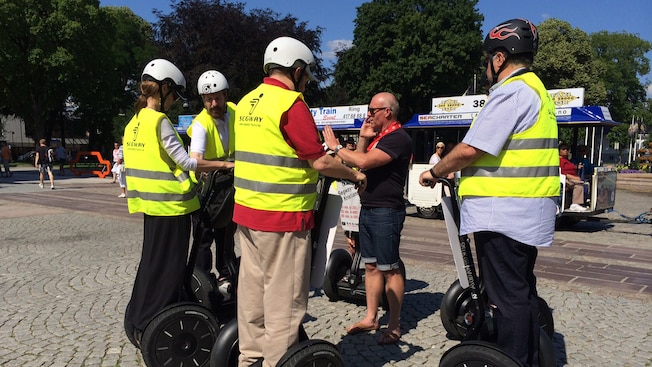 4 adults in safety gear receive instructions on how to use their Segways 4 adults in safety gear receive instructions on how to use their Segways