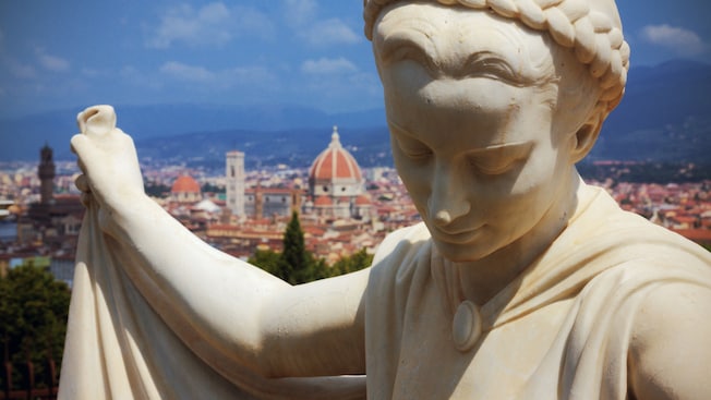 Uma estátua de mármore de uma jovem com o Duomo ao fundo Uma estátua de mármore de uma jovem com o Duomo ao fundo