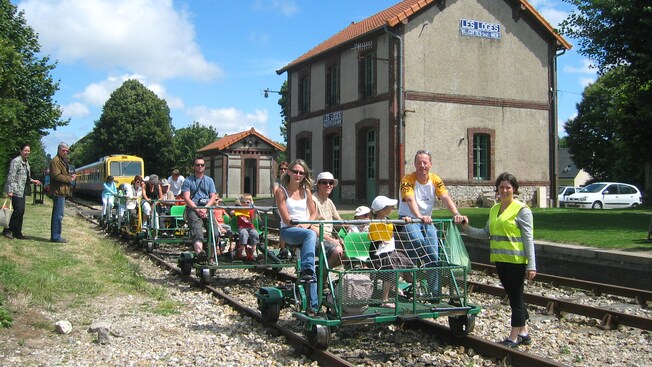 Tourists riding eco-friendly rail cycles on the train tracks