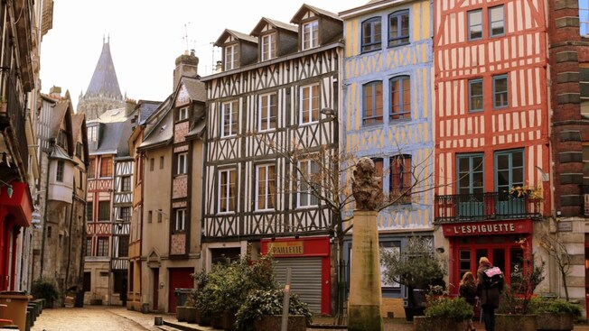 Charming wooden buildings with a bust of an old man on a pillar