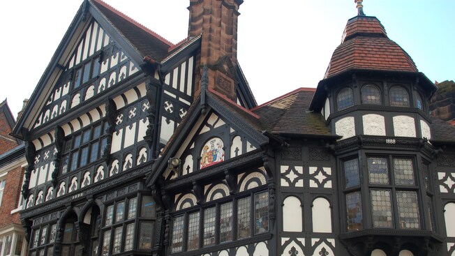 An ornate historic building featuring windows and a crest