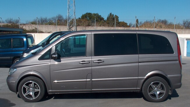 3 vans in a parking lot