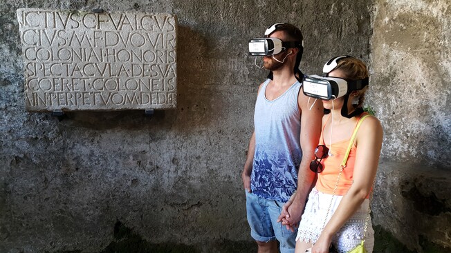 People wearing headsets and holding hands