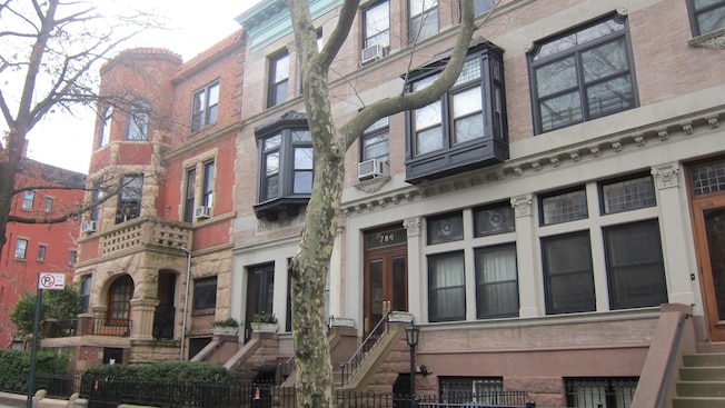 Three story, brick townhouses with bay windows on the second story Three story, brick townhouses with bay windows on the second story