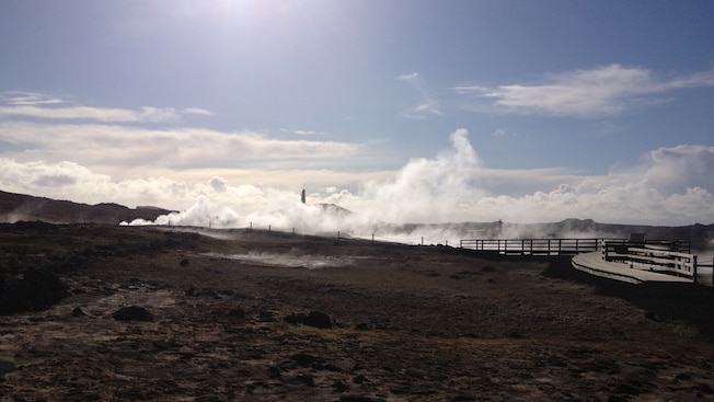 Steam billows up from the hot springs in a moonlike landscape Steam billows up from the hot springs in a moonlike landscape