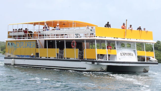 Sightseers on a double deck tour boat sailing through the water