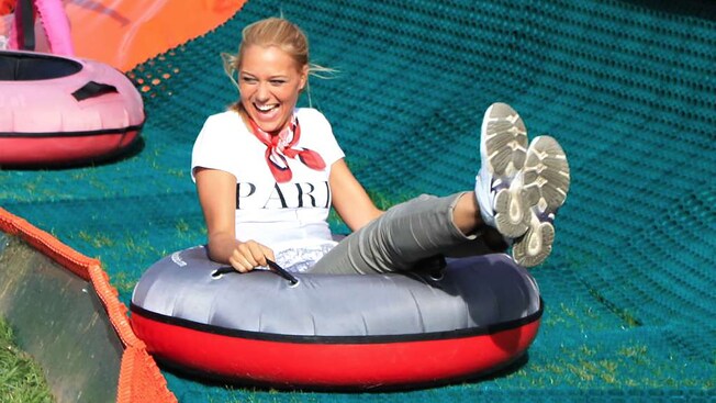 A woman smiles on an inner tube