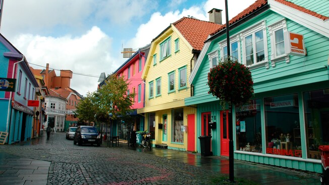 A cobblestone street lined with traditional Norwegian cottage architecture