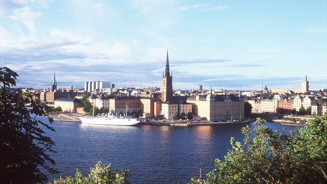 A ship docked alongside the Stockholm skyline