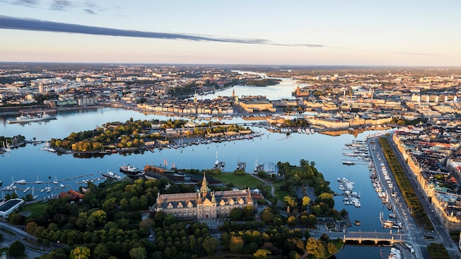 A city with trees built around multiple bodies of water A city with trees built around multiple bodies of water