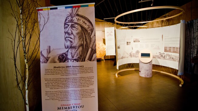A banner inside the First Nations Museum contains a portrait and biography of Grand Chief Henri Membertou
