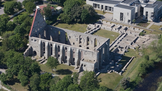 Overhead view of ruins of a stone church with tall arched window openings along the walls and no roof Overhead view of ruins of a stone church with tall arched window openings along the walls and no roof