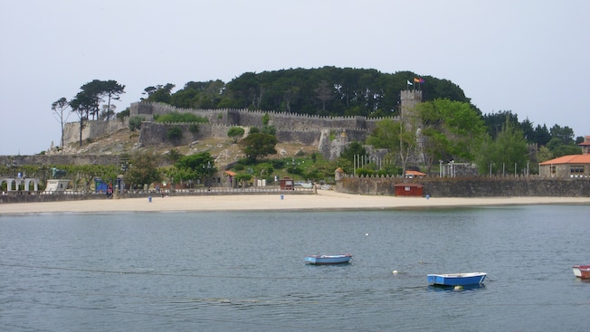 Tethered boats on the water with Monterreal Fortress on shore in the background Tethered boats on the water with Monterreal Fortress on shore in the background