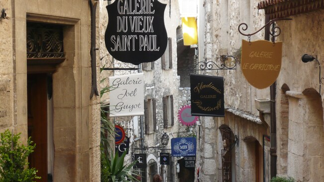 A narrow passageway lined with cafes and boutiques