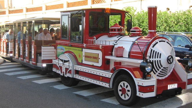 An open air train trolley filled with passengers An open air train trolley filled with passengers