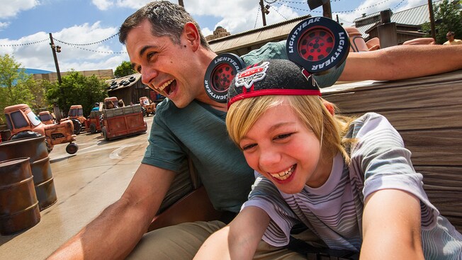 A father and son hold on as their Maters Junkyard Jamboree tractor swings