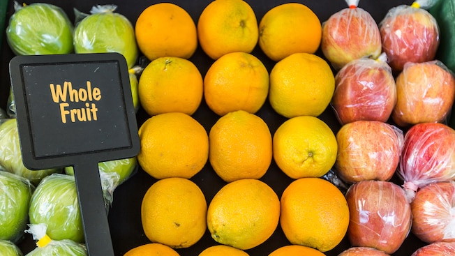 A fruit stand with apples and oranges