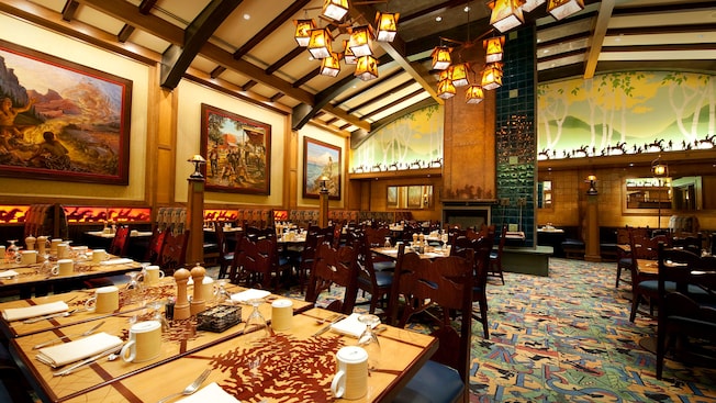 Wide shot of dining tables, framed paintings and Storyteller's Cafe Arts and Crafts decor