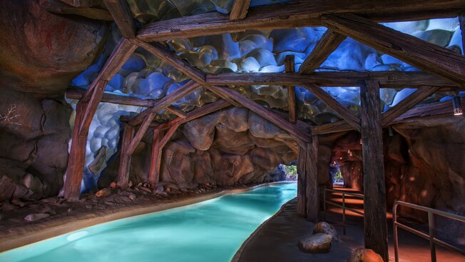 The creek flows through a huge cave supported by wooden beams