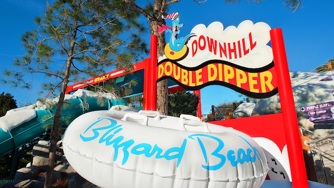 The Downhill Double Dipper sign featuring Ice Gator and a large Blizzard Beach inner tube