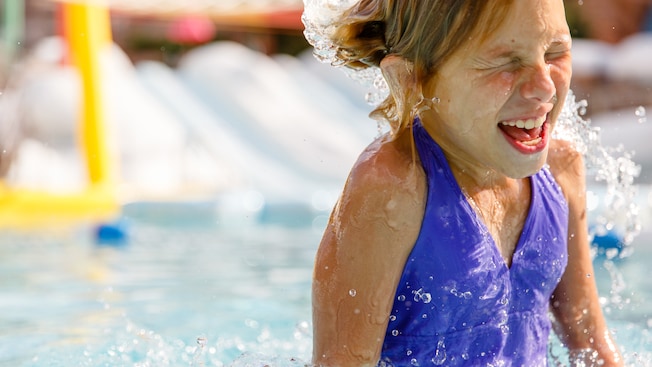 A girl splashing into the pool at Fahrenheit Drops in Disney's Blizzard Beach