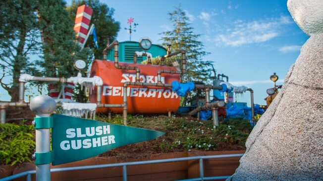 A Slush Gusher pennant-style sign with a large Storm Generator contraption behind it