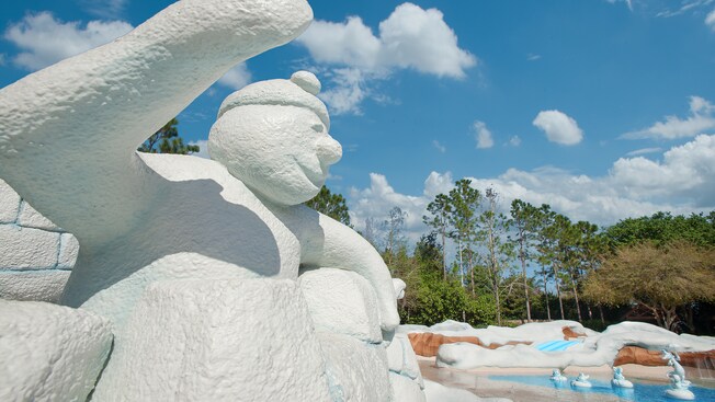 A snowman ice sculpture looking onto a wading pool at Tike's Peak