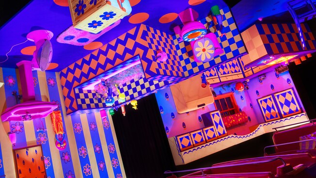 A bathroom hanging from the ceiling and designed with geometric patterns in the attraction at Epcot