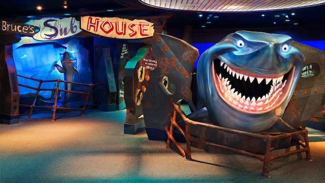 Entrance and sign to Bruce's Sub House with a huge statue of Bruce standing guard