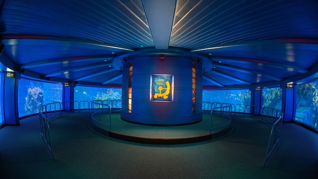A circular room for 360° viewing of the sea life inside a huge aquarium in SeaBase at EPCOT 
