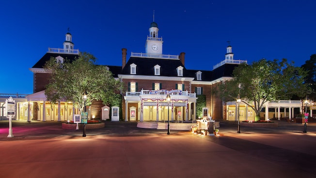 The courtyard and the colonial-style building at The American Adventure lit up at night