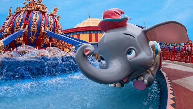 The cheery face of a Dumbo gondola as it flies at the Dumbo the Flying Elephant attraction