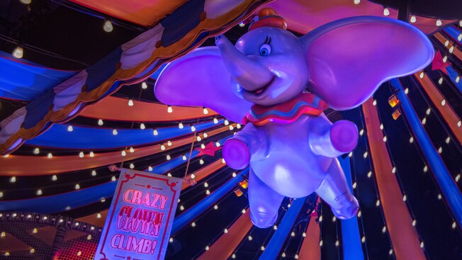 Dumbo flying inside a tent that serves as the interactive wait area for Dumbo, the Flying Elephant