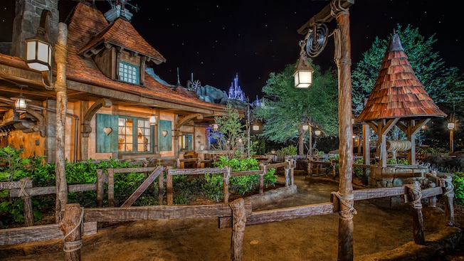 Outside Maurice's charming cottage at night at Enchanted Tales with Belle