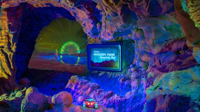 A sign for, and model of Mercury Peak Intergalactic Park with a lunar rover at Space Mountain
