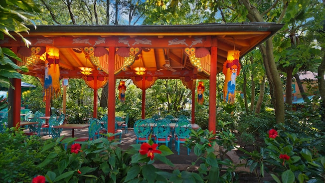 Close-up of wood sculptures in a blue, outdoor dining pavilion