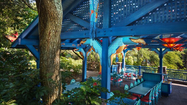 Close-up of wood sculpture of alligator eating a fish 