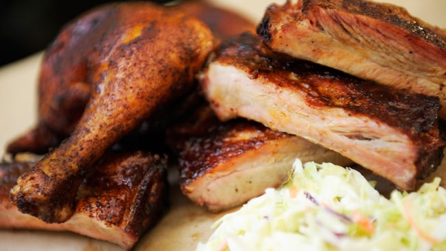 A barbecued Ribs and Chicken Combo plate served with coleslaw
