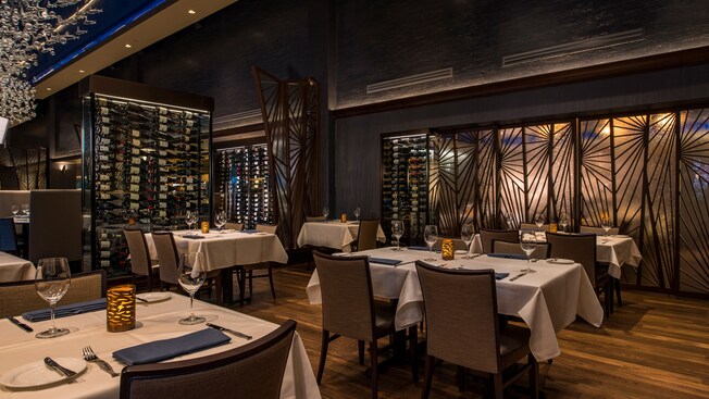 Walls of wine racks divide different areas of the dining room