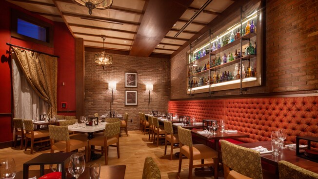 The elegant décor of Trattoria al Forno on Disney’s BoardWalk includes exposed brick and wall sconces.