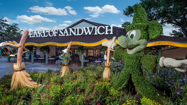 Enchanted brooms and topiary of Sorcerer Mickey outside Earl of Sandwich 