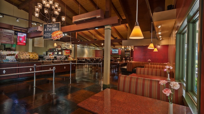 A row of booth tables across from queue area and service counter
