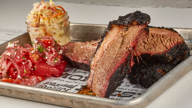 A tray of brisket, tomatoes and slaw