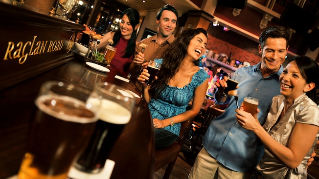 Five young adults enjoying snacks and beer at the bar at Raglan Road Irish Pub and Restaurant