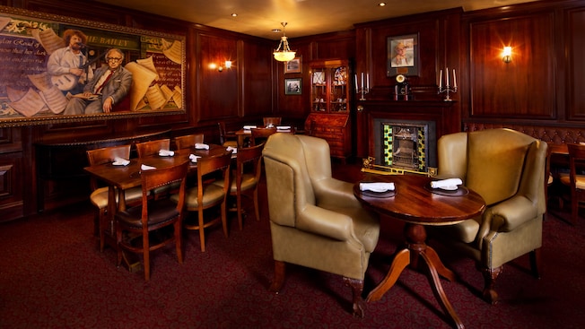 Two oversized leather armchairs and a small table in a lounge area