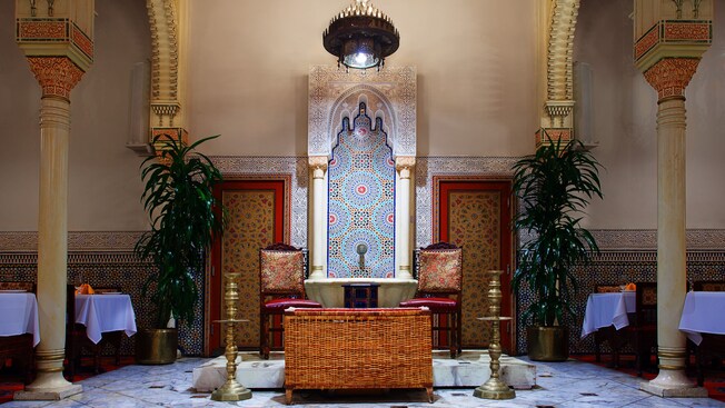 Dining room stage area with rattan basket and 2 chairs for musicians