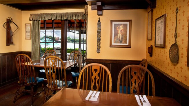 Two corner tables near walls lined with English memorabilia 