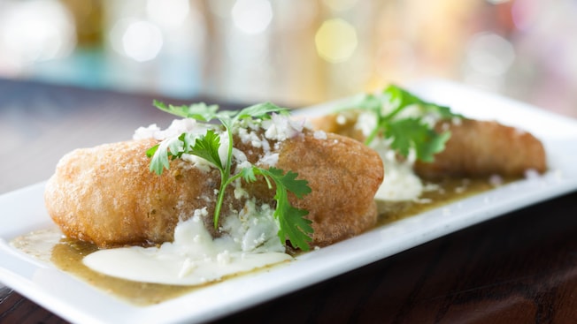 Battered quesadillas stuffed with mushrooms, corn, queso fresco, huitlacoche, topped with sour cream