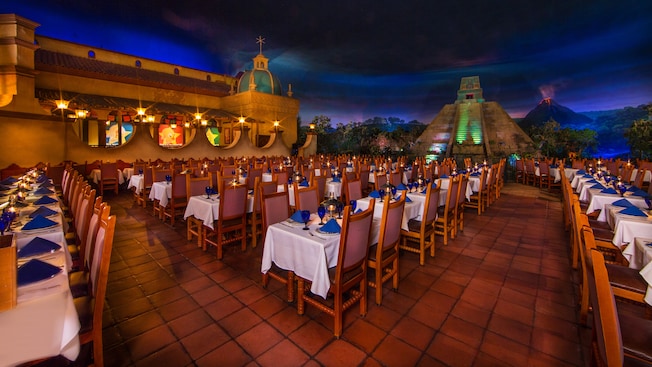 View of dining area with tile floors, tables and Mayan pyramid in background